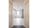Bathroom view through doorway featuring tiled floor, soaking tub, glass shower, and bright natural light at 27425 Jones Loop Rd, Punta Gorda, FL 33982