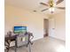 Bedroom featuring neutral walls, a ceiling fan and a desk to provide a relaxing space at 27425 Jones Loop Rd, Punta Gorda, FL 33982