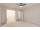 Bright bedroom with plush carpeting and a ceiling fan; walk-in closet provides ample storage at 27425 Jones Loop Rd, Punta Gorda, FL 33982