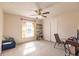 Bedroom with neutral walls, carpet flooring, ceiling fan, and a window at 27425 Jones Loop Rd, Punta Gorda, FL 33982