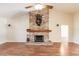 Beautiful stone fireplace with mantel and hearth creates a cozy focal point at 27425 Jones Loop Rd, Punta Gorda, FL 33982