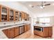 Open kitchen with custom cabinets, granite counters, stainless appliances, and hardwood floors at 27425 Jones Loop Rd, Punta Gorda, FL 33982