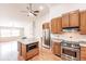 Bright kitchen features stainless steel appliances, granite countertops, and a central island with microwave at 27425 Jones Loop Rd, Punta Gorda, FL 33982