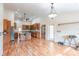Kitchen view from dining room showcases wood cabinets, granite countertops, stainless appliances, and center island with seating at 27425 Jones Loop Rd, Punta Gorda, FL 33982
