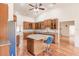 Open kitchen with custom cabinets, granite counters, a center island, and stainless appliances at 27425 Jones Loop Rd, Punta Gorda, FL 33982