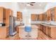 Bright kitchen with wood cabinets, granite countertops, and stainless steel appliances at 27425 Jones Loop Rd, Punta Gorda, FL 33982