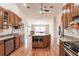 Open kitchen with custom cabinets, granite counters, a center island, and tile backsplash at 27425 Jones Loop Rd, Punta Gorda, FL 33982