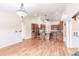 Open-concept view into kitchen with wooden cabinets, stainless steel refrigerator, island, and bar stool seating at 27425 Jones Loop Rd, Punta Gorda, FL 33982
