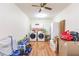 Laundry room with essential appliances, storage cabinets, and durable laminate flooring at 27425 Jones Loop Rd, Punta Gorda, FL 33982