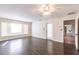 Living room boasts wood floors, natural light from a large window, and a door to the outside at 27425 Jones Loop Rd, Punta Gorda, FL 33982