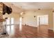 Open-concept living room featuring hardwood floors, ceiling fan, and neutral paint at 27425 Jones Loop Rd, Punta Gorda, FL 33982