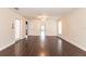 Living room with hardwood floors, white walls, ceiling fan, and abundant natural light from windows and glass door at 27425 Jones Loop Rd, Punta Gorda, FL 33982