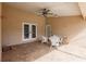 Covered patio with ceiling fan and outdoor seating; a perfect spot for relaxing and entertaining guests at 27425 Jones Loop Rd, Punta Gorda, FL 33982