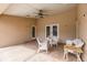 Covered patio featuring decorative concrete, ceiling fan, and outdoor seating; great for entertaining at 27425 Jones Loop Rd, Punta Gorda, FL 33982