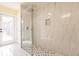 Walk-in shower featuring contemporary tile work, glass enclosure, and modern fixtures at 27425 Jones Loop Rd, Punta Gorda, FL 33982
