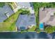 Aerial shot of a waterfront home with a pool, lush landscaping, and private dock on a canal at 4708 Clipper Dr, Bradenton, FL 34208
