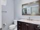 Updated bathroom featuring dark wood cabinet and decorative mirror at 4708 Clipper Dr, Bradenton, FL 34208