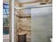 Bathroom with glass shower doors and view to the outside screened-in pool area at 4708 Clipper Dr, Bradenton, FL 34208