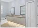 Bathroom featuring dual sinks, vanity, garden tub and tile floors at 4708 Clipper Dr, Bradenton, FL 34208