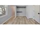 Upstairs bedroom with wood-look tile floors and closet at 4708 Clipper Dr, Bradenton, FL 34208
