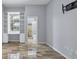 Bright bedroom featuring wood-look tile floors, built-in shelving, and a view to the bathroom at 4708 Clipper Dr, Bradenton, FL 34208