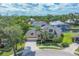 Beautiful exterior of a home with a lush landscaped yard and a boat in the canal behind the property at 4708 Clipper Dr, Bradenton, FL 34208