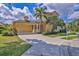 Beautiful home exterior with well-manicured lawn, mature landscaping and a two-car garage on a sunny day at 4708 Clipper Dr, Bradenton, FL 34208