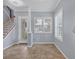 Inviting foyer showcasing a decorative front door, tile floors, and staircase at 4708 Clipper Dr, Bradenton, FL 34208