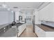 This stylish kitchen features white cabinetry, granite countertops, and stainless steel appliances at 4708 Clipper Dr, Bradenton, FL 34208