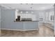 Spacious eat in kitchen featuring white cabinetry, granite counters, breakfast bar, and stainless appliances at 4708 Clipper Dr, Bradenton, FL 34208