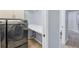 Bright laundry room with washer, dryer, shelving, and counter space for folding at 4708 Clipper Dr, Bradenton, FL 34208