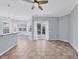 Open living room featuring tile floors, neutral paint, built in seating, and a sliding glass door at 4708 Clipper Dr, Bradenton, FL 34208