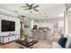 Open concept living space with a modern kitchen, breakfast bar, and a cozy living room area with decor at 4708 Clipper Dr, Bradenton, FL 34208
