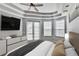 A bright main bedroom with neutral tones, stylish tray ceiling, and glass doors to outdoor space at 4708 Clipper Dr, Bradenton, FL 34208