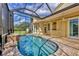 Stunning in-ground pool inside screened lanai with brick pavers and peaceful backyard views at 4708 Clipper Dr, Bradenton, FL 34208
