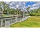 Picturesque view of a waterfront property featuring a private dock and boat lift at 4708 Clipper Dr, Bradenton, FL 34208