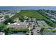 Stunning aerial view showcasing the community's pool, tennis courts, and beautiful waterfront views at 653 Cedars Ct, Longboat Key, FL 34228