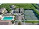 Aerial view of beach condos near a pool, tennis courts and lots of parking at 653 Cedars Ct, Longboat Key, FL 34228