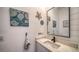 Nautical-themed half bathroom with shiplap walls, a decorative mirror, and a stone countertop sink at 653 Cedars Ct, Longboat Key, FL 34228