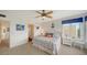 Comfortable bedroom with ample natural light, coastal decor, carpet, and a queen-sized bed at 653 Cedars Ct, Longboat Key, FL 34228