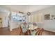 Dining Room featuring a glass table and stylish chairs by windows and kitchen at 653 Cedars Ct, Longboat Key, FL 34228