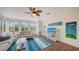 Living room featuring two sofas, ceiling fan, beach decor and lots of windows at 653 Cedars Ct, Longboat Key, FL 34228