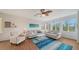 A living room with white walls, two sofas, an armchair, and coastal decor at 653 Cedars Ct, Longboat Key, FL 34228