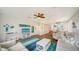 Living room with beach decor, ceiling fan, and an open layout to the kitchen at 653 Cedars Ct, Longboat Key, FL 34228