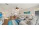 A beachy living room with stairway, ceiling fan, and kitchen access at 653 Cedars Ct, Longboat Key, FL 34228