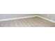 Close-up of carpeted corner featuring white baseboards in a neutral-toned room at 7486 Divot Loop # 7486, Bradenton, FL 34202