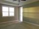 A carpeted bedroom with a window letting in natural light and an open entry at 7486 Divot Loop # 7486, Bradenton, FL 34202