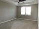 A brightly lit room featuring a ceiling fan and a large window at 7486 Divot Loop # 7486, Bradenton, FL 34202