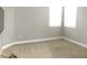 Bedroom featuring corner windows and neutral carpeting, offering natural light and comfort at 7486 Divot Loop # 7486, Bradenton, FL 34202