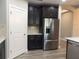 A kitchen featuring stainless steel appliances and dark cabinetry with white countertop and subway tile backsplash at 7486 Divot Loop # 7486, Bradenton, FL 34202
